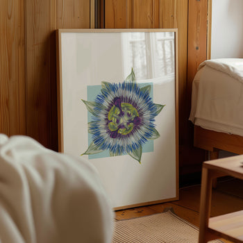 Framed artwork of a colorful passionfruit flower on a wall in a room with wooden paneling.