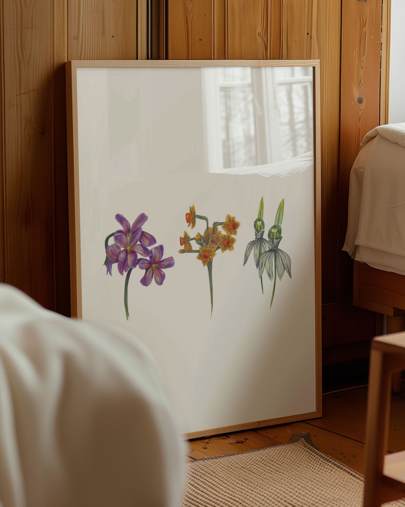3 flower art print in wooden frame and leaning against wooden wall