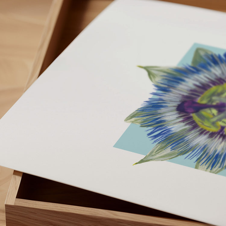 Colorful floral illustration of a passionfruit flower on a white card with a wooden surface underneath