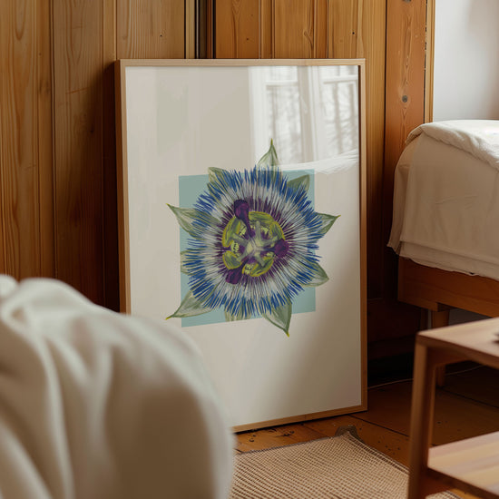 Framed artwork of a colorful passionfruit flower on a wall in a room with wooden paneling.