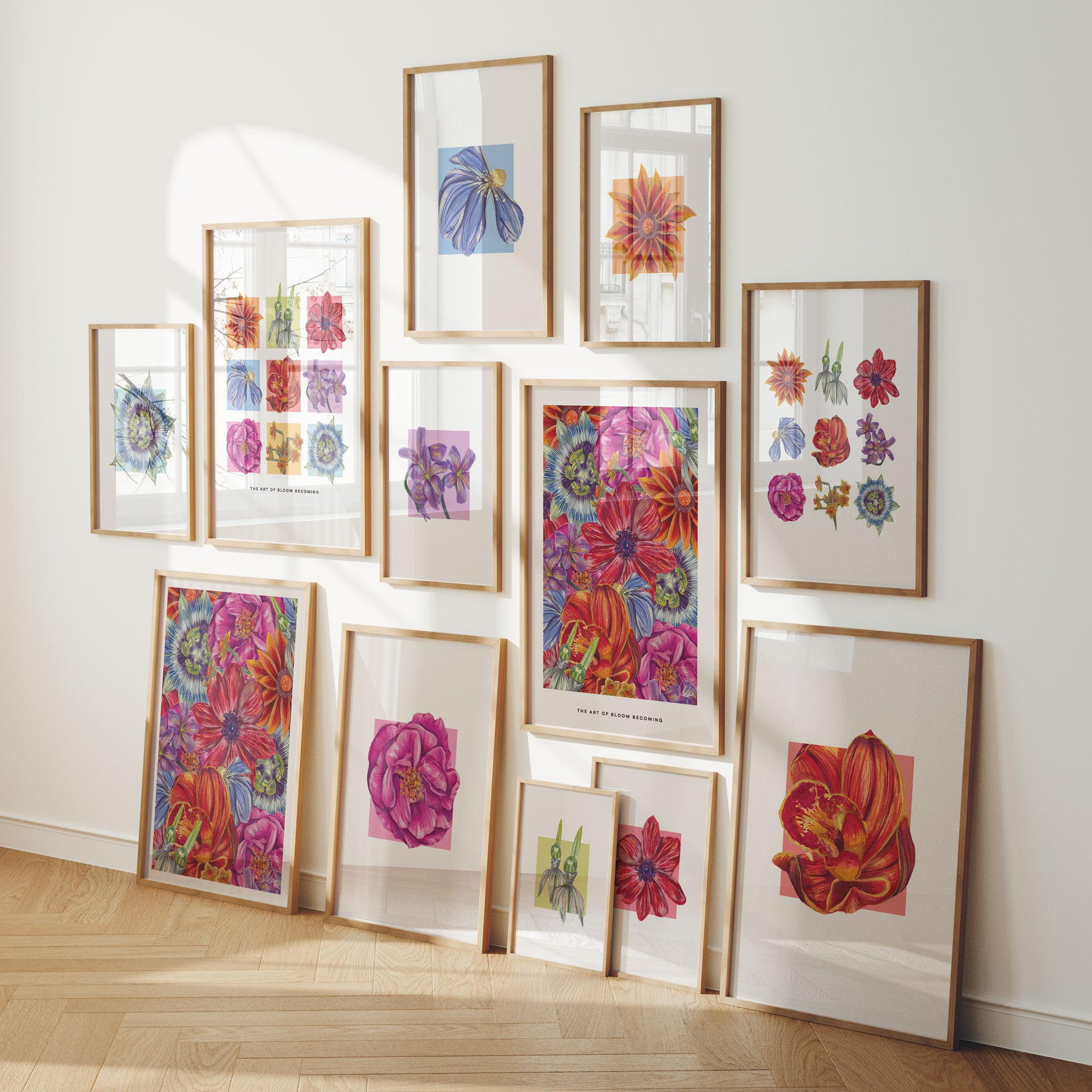 Collection of colourful bright framed floral artworks of varying sizes displayed on a wall