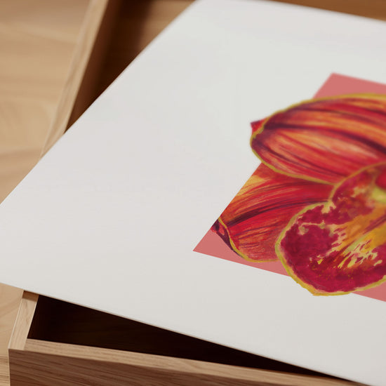 Close up of orange orchid print on a wooden surface