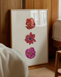 3 flower art print in wooden frame and leaning against wooden wall