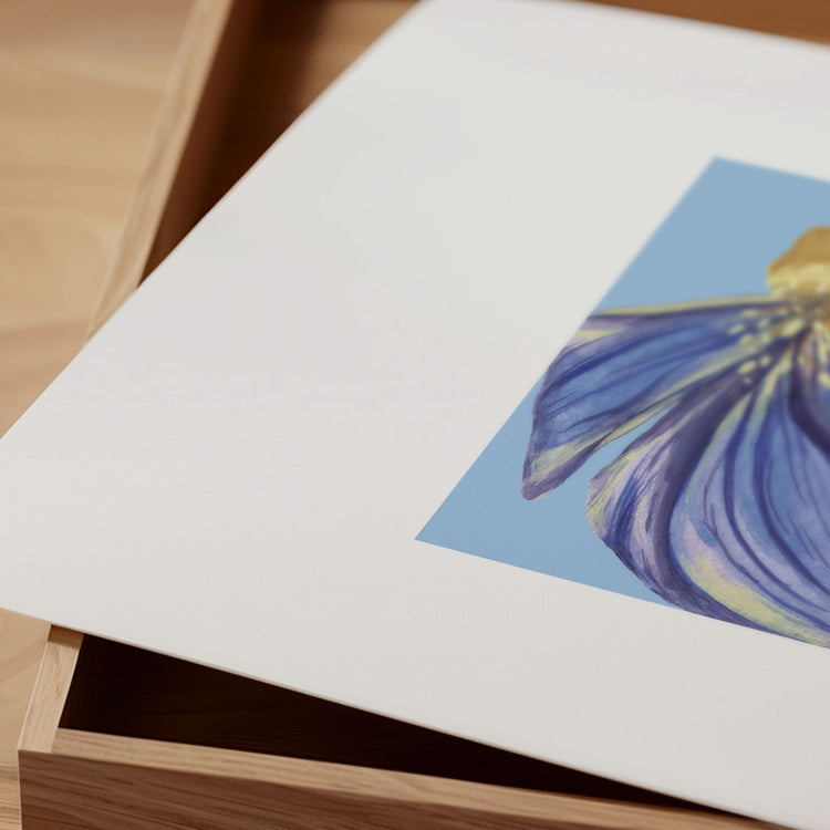 Blue dune flower illustration on a white card with a wooden surface underneath