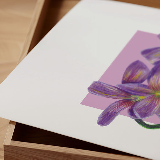 Purple and pink flower illustration on a white card with a wooden surface underneath