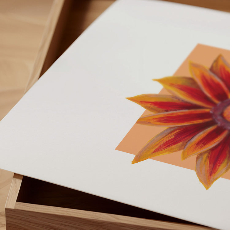 Red and orange floral print on a white card with a wooden box in the background