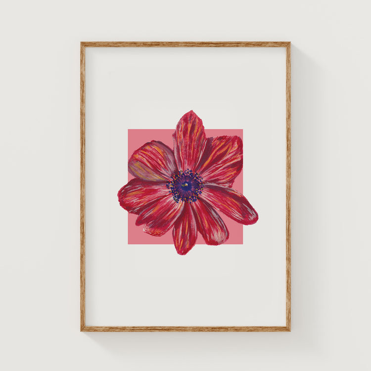 Framed artwork of a red and blue flower on a white background