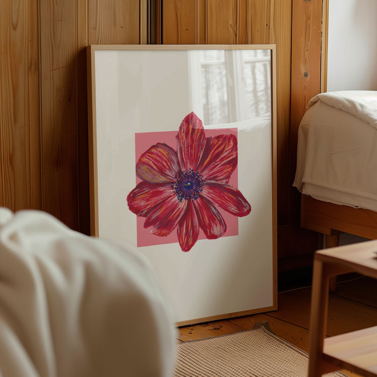 Framed artwork of a red flower on a wooden wall