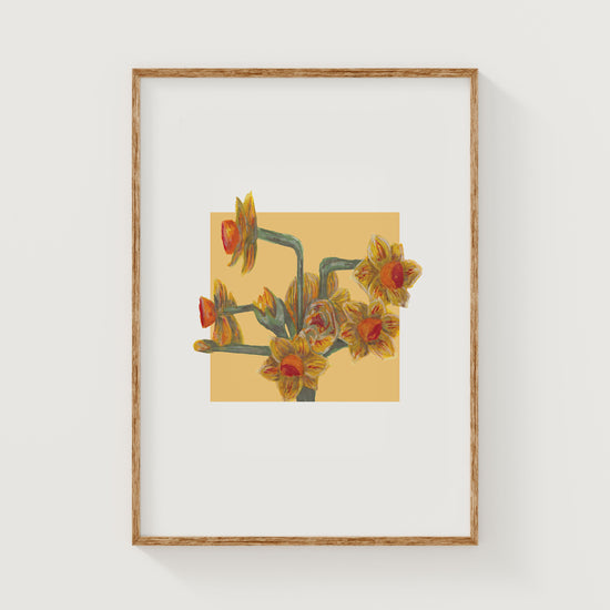 Framed artwork of a yellow daffodil floral design on a yellow square background