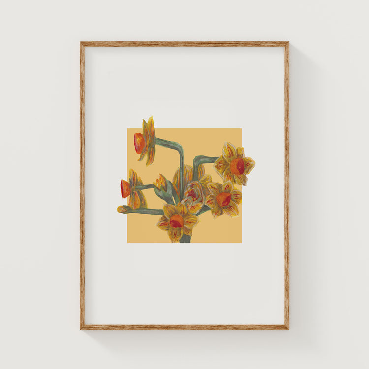 Framed artwork of a yellow daffodil floral design on a yellow square background